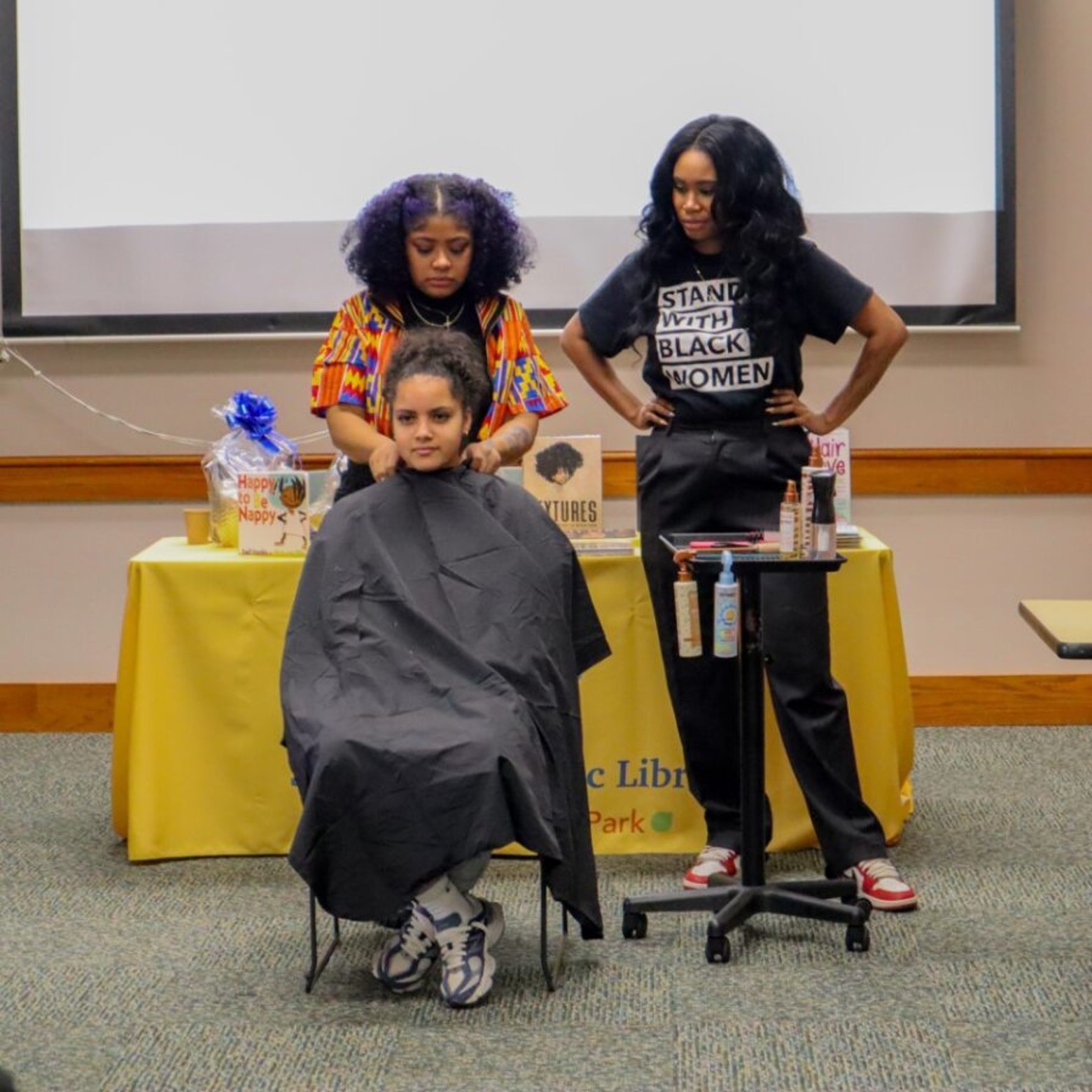 Simone Booth (right) and Reina Thomas (left) of NW2D Salon at BC/CLC Co-Sponsored Celebration of Natural Hair Care Event for Black History Month at Springdale Public Library.